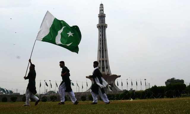 Pakistani boys with flag during Pakistan day celebration
